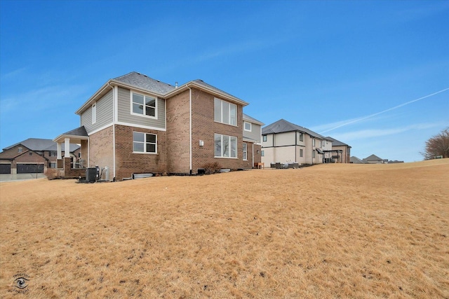 rear view of property with brick siding