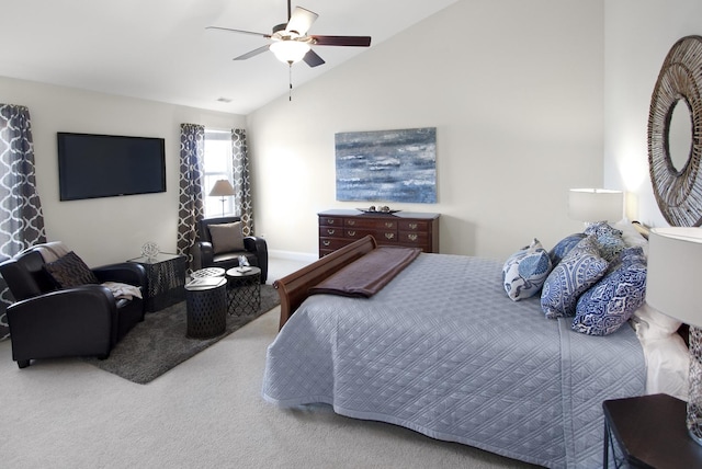 carpeted bedroom featuring lofted ceiling and a ceiling fan