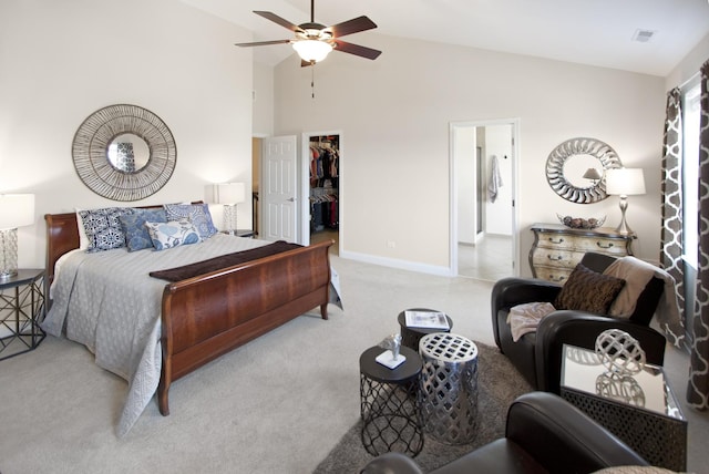 bedroom featuring light carpet, visible vents, a spacious closet, high vaulted ceiling, and a closet