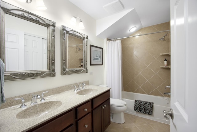 bathroom featuring shower / tub combo with curtain, tile patterned flooring, a sink, and toilet