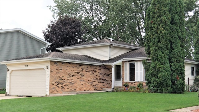 view of front facade with a garage, a front yard, brick siding, and roof with shingles