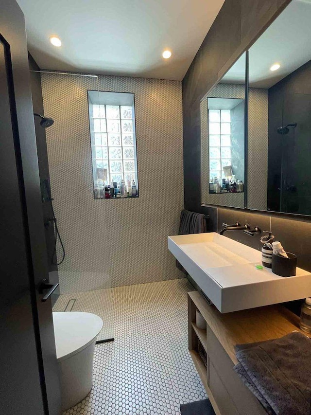 bathroom with recessed lighting, a wealth of natural light, and a walk in shower