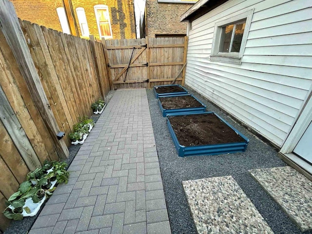 view of patio featuring a gate and fence