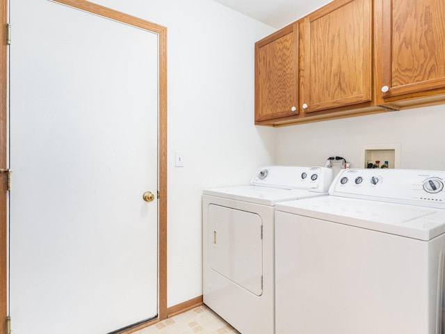 laundry area with light floors, separate washer and dryer, cabinet space, and baseboards