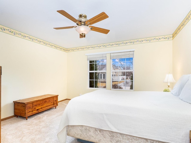 carpeted bedroom with a ceiling fan and baseboards