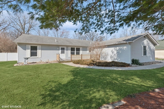 view of front of house with a front yard and fence