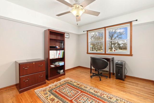 office with light wood-style floors, baseboards, and a ceiling fan