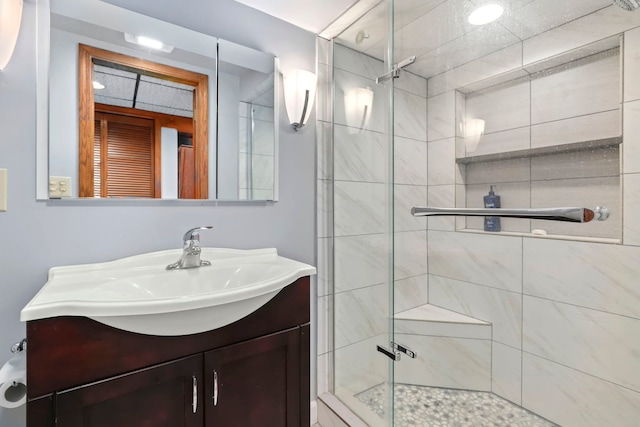 bathroom featuring a shower stall and vanity