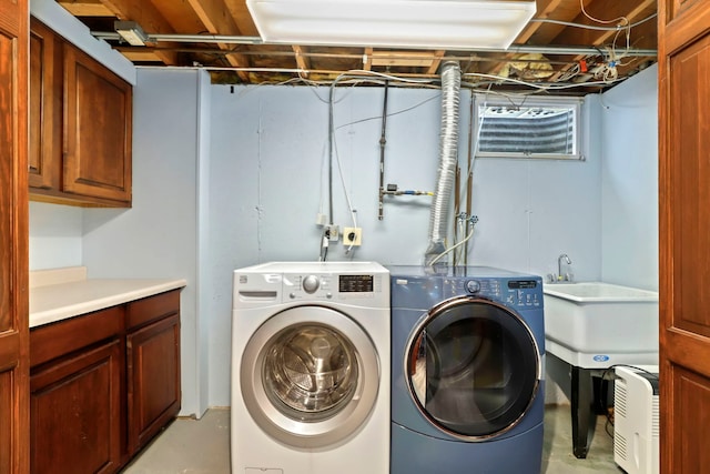 laundry room featuring washing machine and clothes dryer and cabinet space