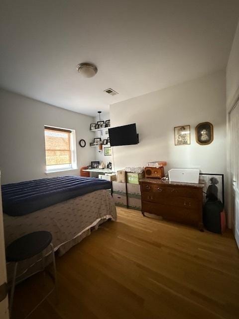 bedroom with visible vents and light wood-style flooring