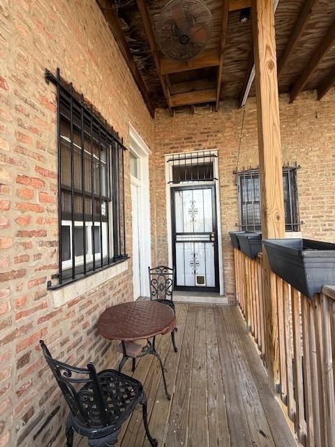 entrance to property featuring brick siding