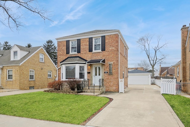 traditional home with brick siding, a detached garage, fence, an outdoor structure, and a front lawn