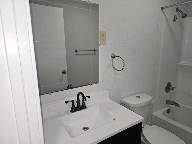 full bath with  shower combination, a textured wall, toilet, and vanity