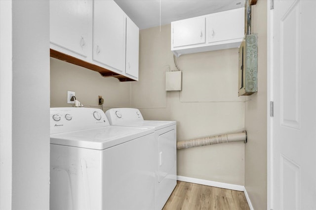 washroom with cabinet space, light wood-style flooring, baseboards, and separate washer and dryer