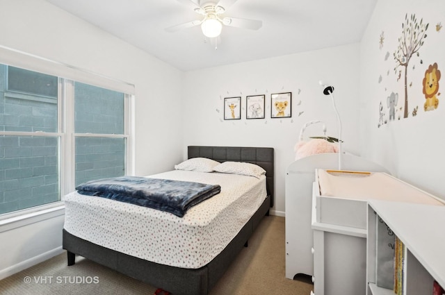 bedroom with multiple windows, carpet flooring, a ceiling fan, and baseboards