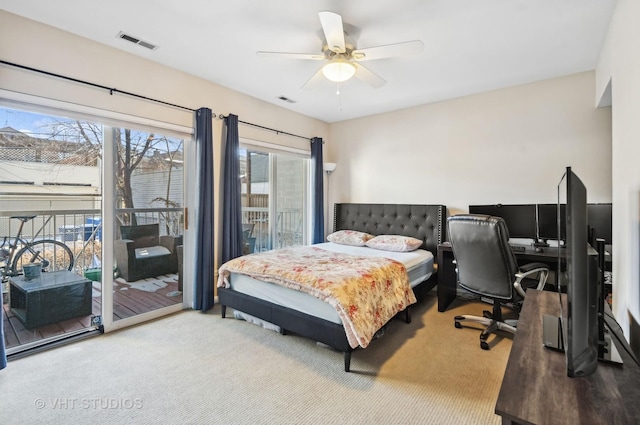 carpeted bedroom with access to exterior, visible vents, and a ceiling fan