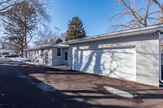 exterior space featuring a garage and aphalt driveway