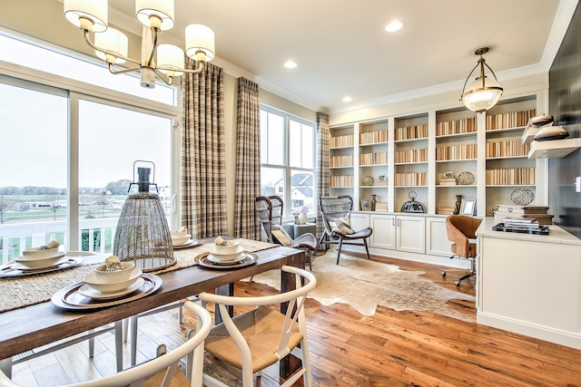 dining room featuring a chandelier, recessed lighting, light wood-type flooring, and crown molding