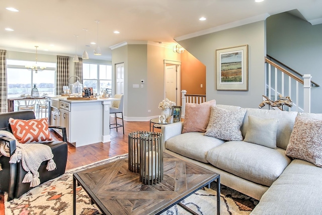 living room featuring recessed lighting, baseboards, stairway, light wood-type flooring, and crown molding