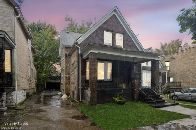 bungalow-style home featuring brick siding