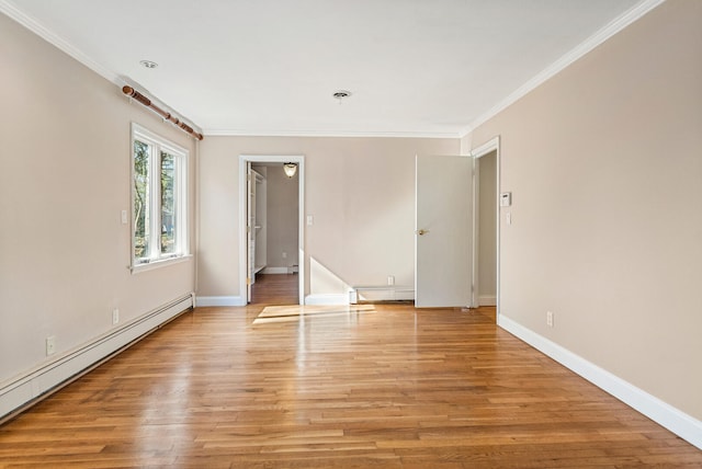 unfurnished room featuring light wood finished floors, baseboards, a baseboard heating unit, and crown molding