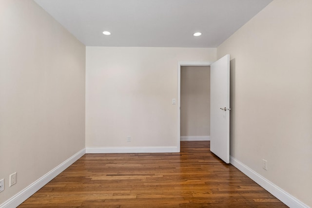 unfurnished room with baseboards, wood finished floors, and recessed lighting