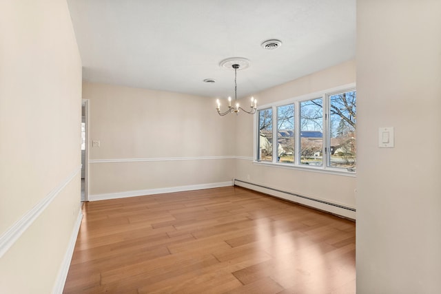 unfurnished room featuring baseboards, visible vents, baseboard heating, light wood-type flooring, and a notable chandelier