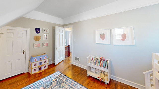 game room featuring lofted ceiling, baseboards, visible vents, and dark wood-style flooring