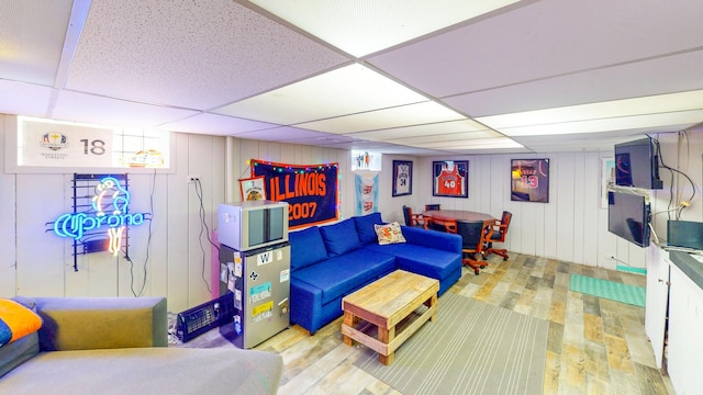 living room featuring a paneled ceiling and light wood finished floors