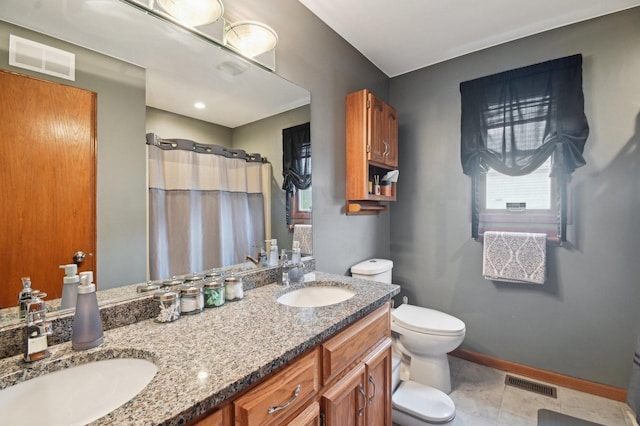 bathroom featuring baseboards, visible vents, a sink, and toilet