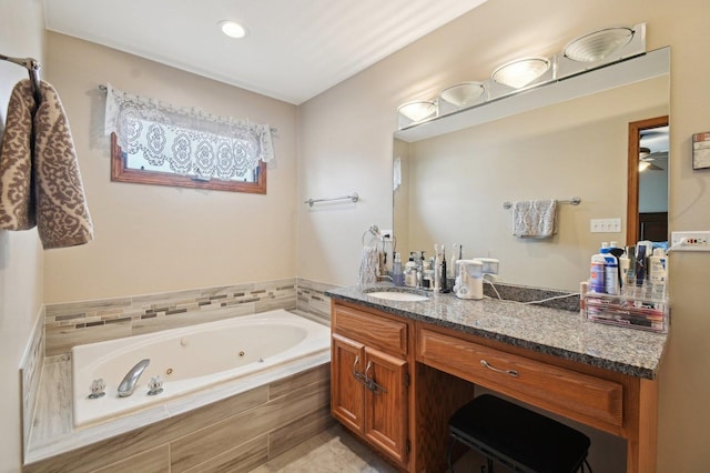 bathroom with a whirlpool tub and vanity