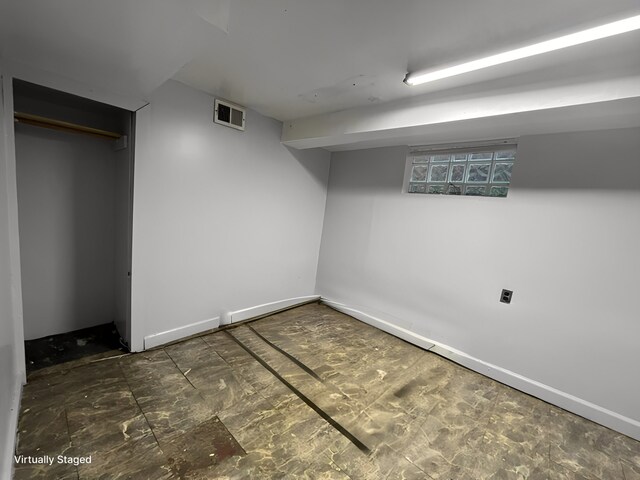 finished basement featuring visible vents and baseboards