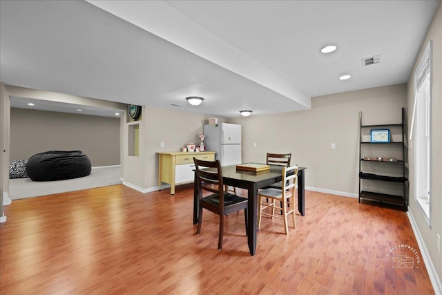 dining room featuring light wood-type flooring, visible vents, baseboards, and recessed lighting