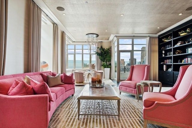 sunroom / solarium with an inviting chandelier, plenty of natural light, and a view of city