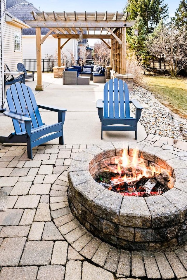 view of patio with an outdoor living space with a fire pit, fence, and a pergola