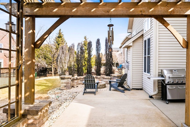 view of patio featuring a grill, fence, and a pergola