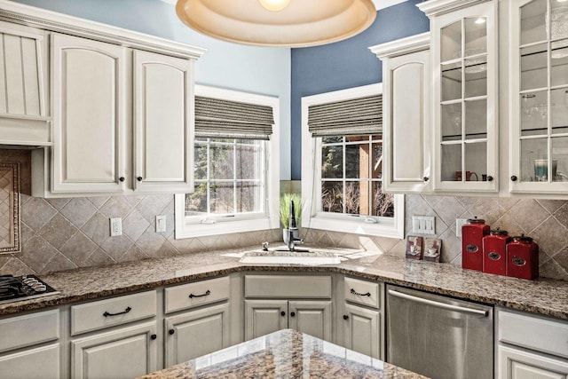 kitchen featuring a sink, black gas cooktop, glass insert cabinets, and stainless steel dishwasher