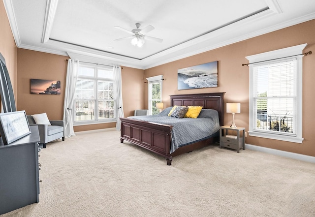 bedroom with ornamental molding, a raised ceiling, and light carpet