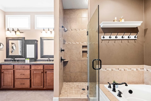 full bath featuring tile patterned flooring, a garden tub, a sink, and a shower stall