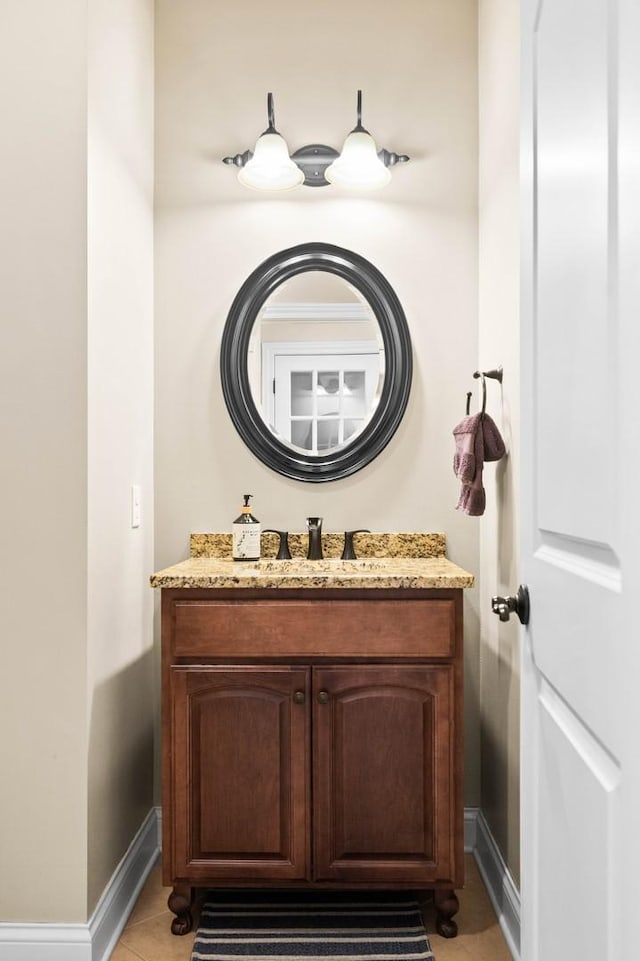 bathroom featuring tile patterned floors, vanity, and baseboards