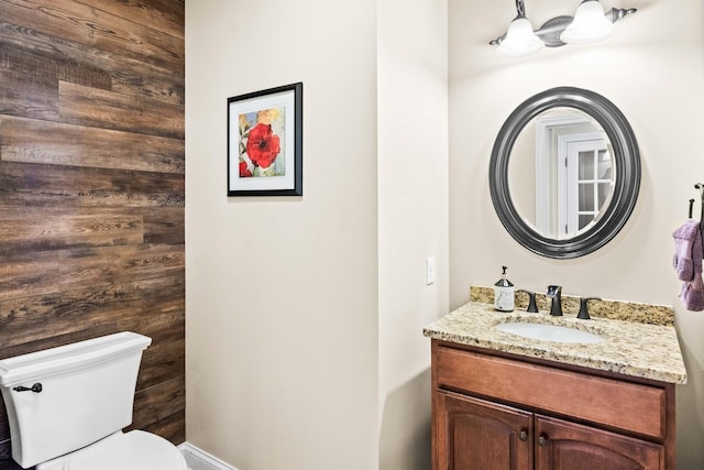 half bathroom with toilet and vanity