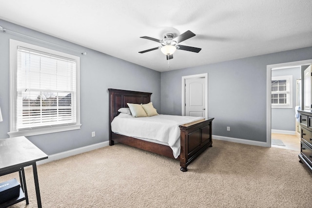 bedroom featuring baseboards, ceiling fan, and light colored carpet