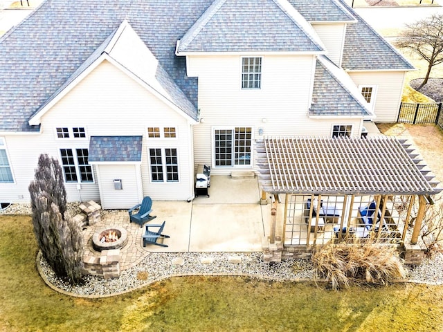 back of property featuring an outdoor fire pit, a shingled roof, a lawn, a pergola, and a patio area