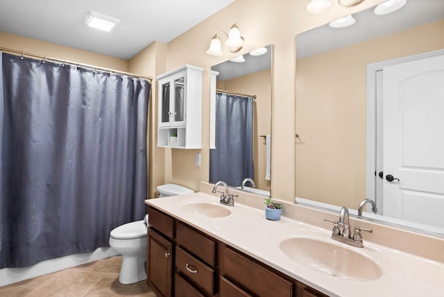 bathroom featuring tile patterned flooring, a sink, toilet, and double vanity