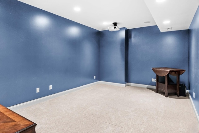 carpeted empty room with baseboards and recessed lighting