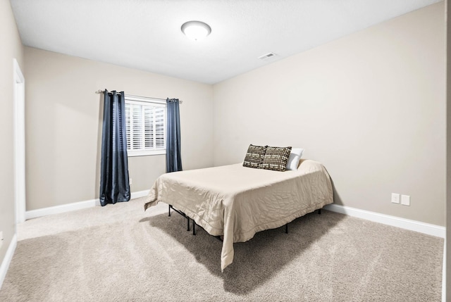 bedroom featuring carpet floors, visible vents, and baseboards