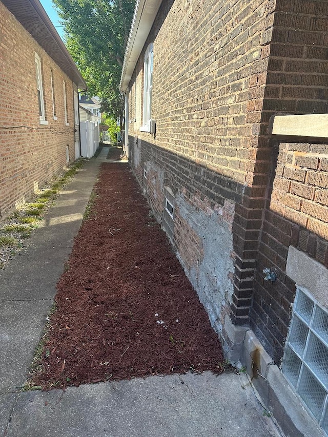 view of side of property with brick siding