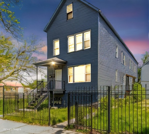 view of front facade featuring a fenced front yard and a gate