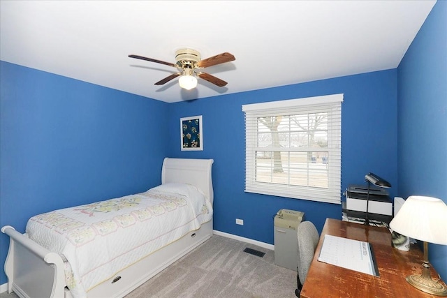 carpeted bedroom with a ceiling fan, visible vents, and baseboards