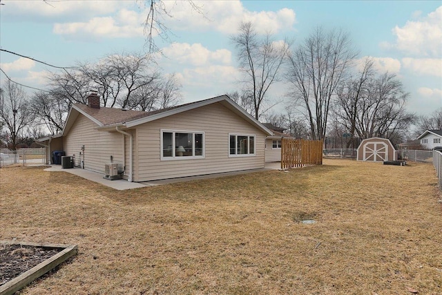 view of property exterior with central AC unit, an outdoor structure, fence, a yard, and a chimney